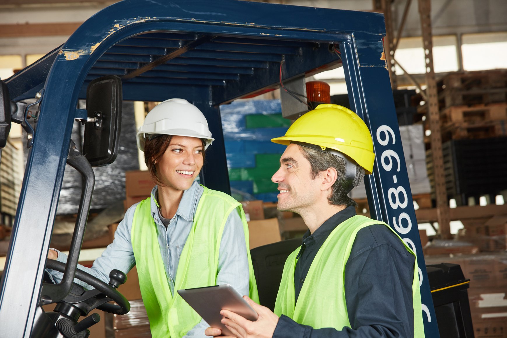 Warehouse Worker and Woman on Forklift